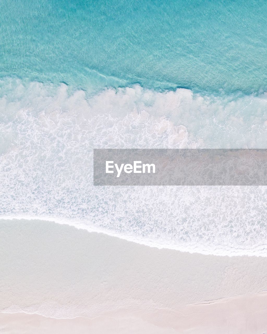 High angle view of waves rushing towards shore