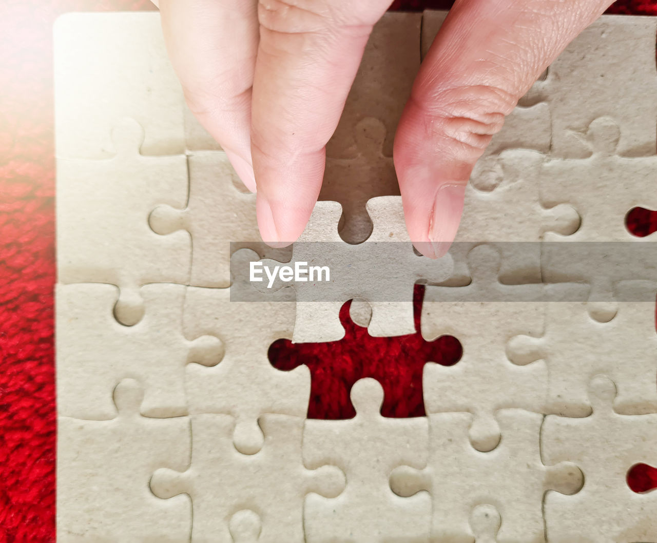 puzzle, jigsaw piece, jigsaw puzzle, solution, strategy, hand, toy, cooperation, leisure activity, teamwork, leisure games, shape, indoors, incomplete, togetherness, adult, unity, close-up, relaxation, red, high angle view, planning, pattern, holding, large group of objects, interlocked, organization