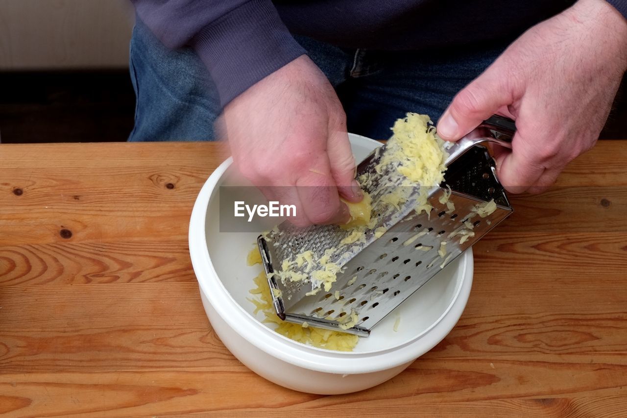 MIDSECTION OF MAN PREPARING FOOD