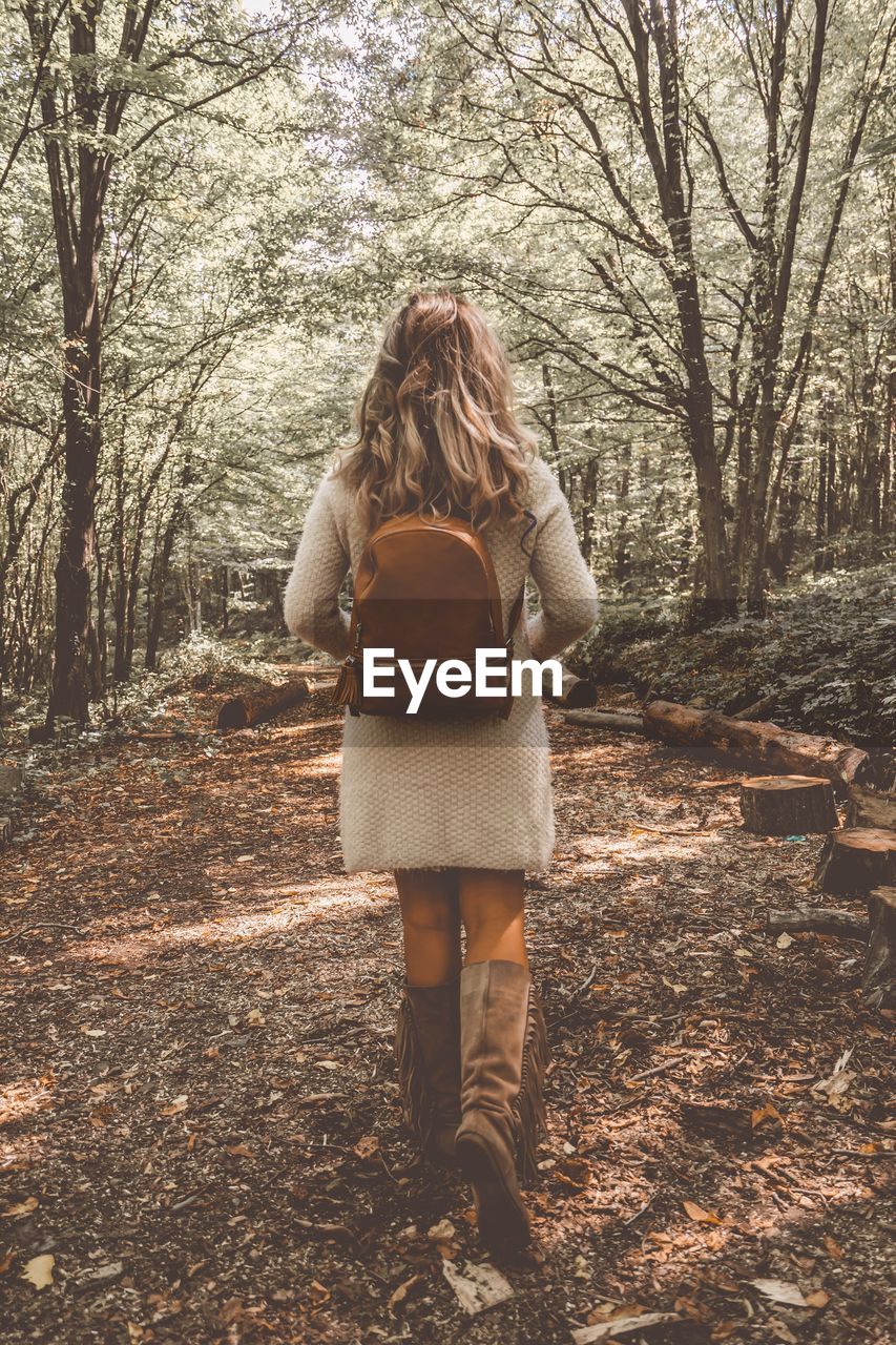 Rear view of woman walking on landscape