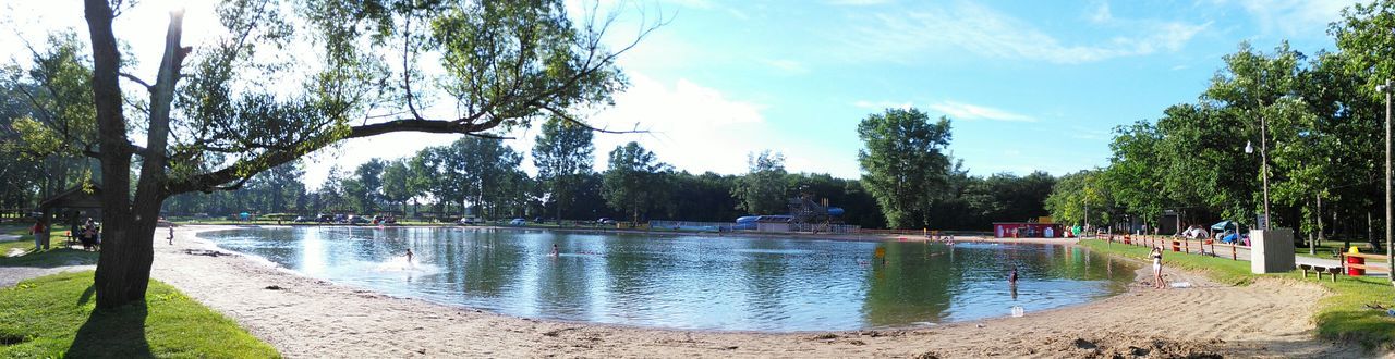 Panoramic view of lake amidst trees against sky