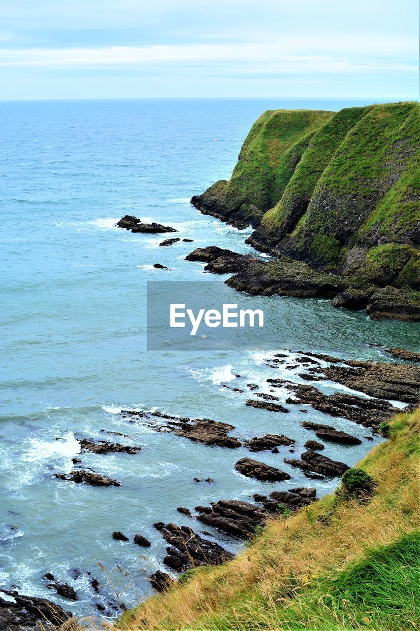 SCENIC VIEW OF SEA AND ROCKS AGAINST SKY