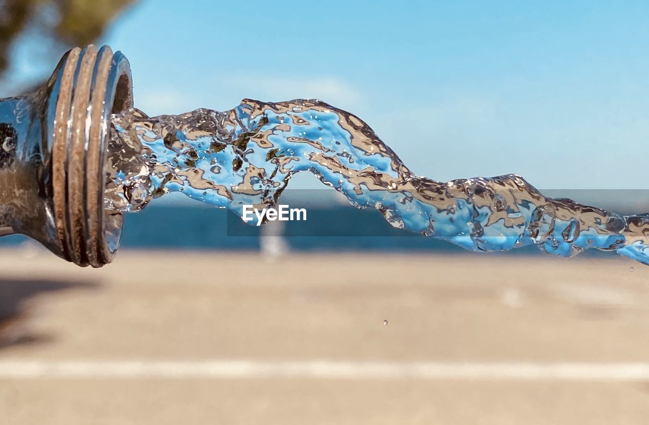 Close-up of water on land against sky