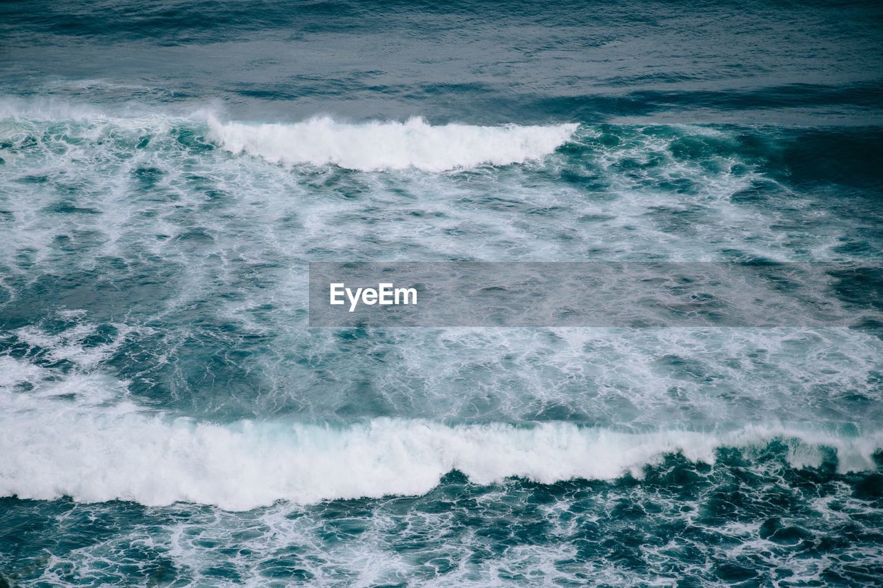 High angle view of waves flowing in sea