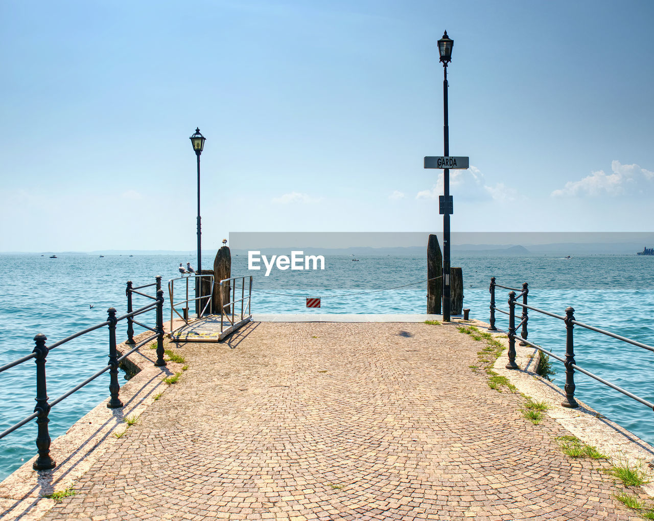 Veiw to the garda lake from pier, summer holiday in italy.