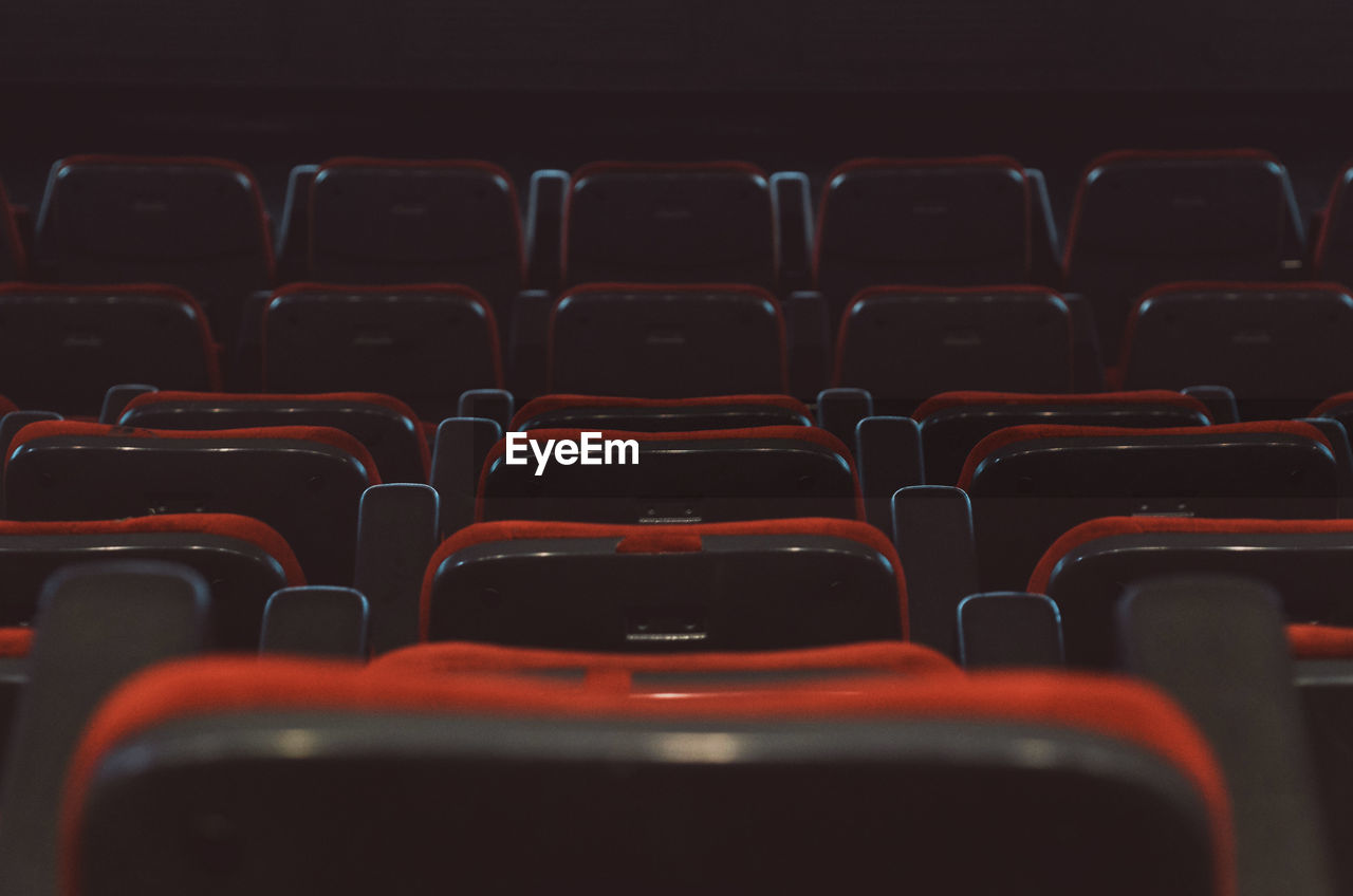 Full frame shot of empty red seats in movie theater