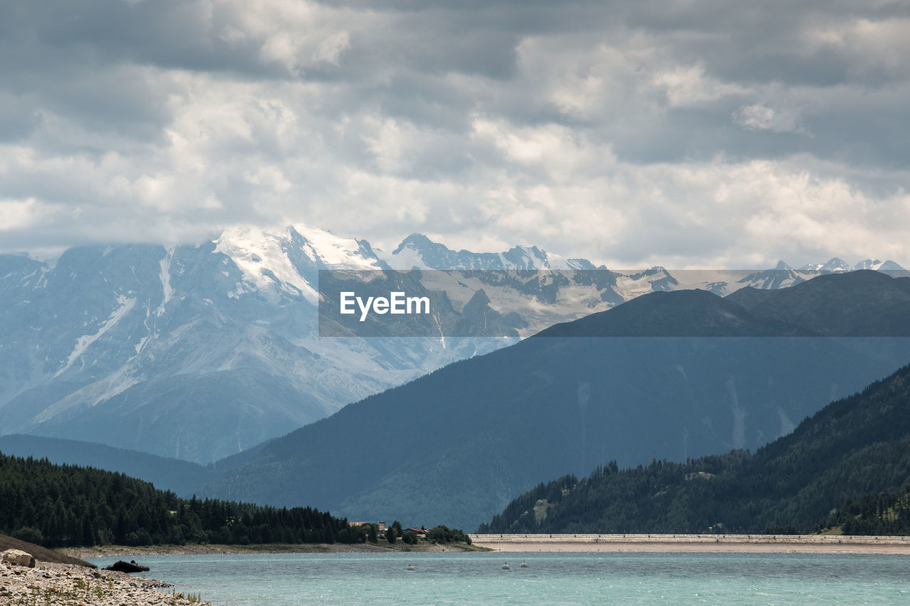 Scenic view of mountains against cloudy sky