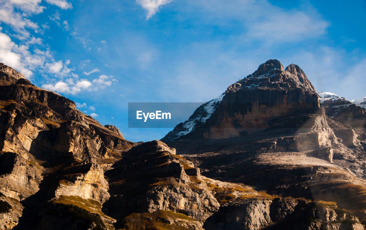 Low angle view of rock formations against sky