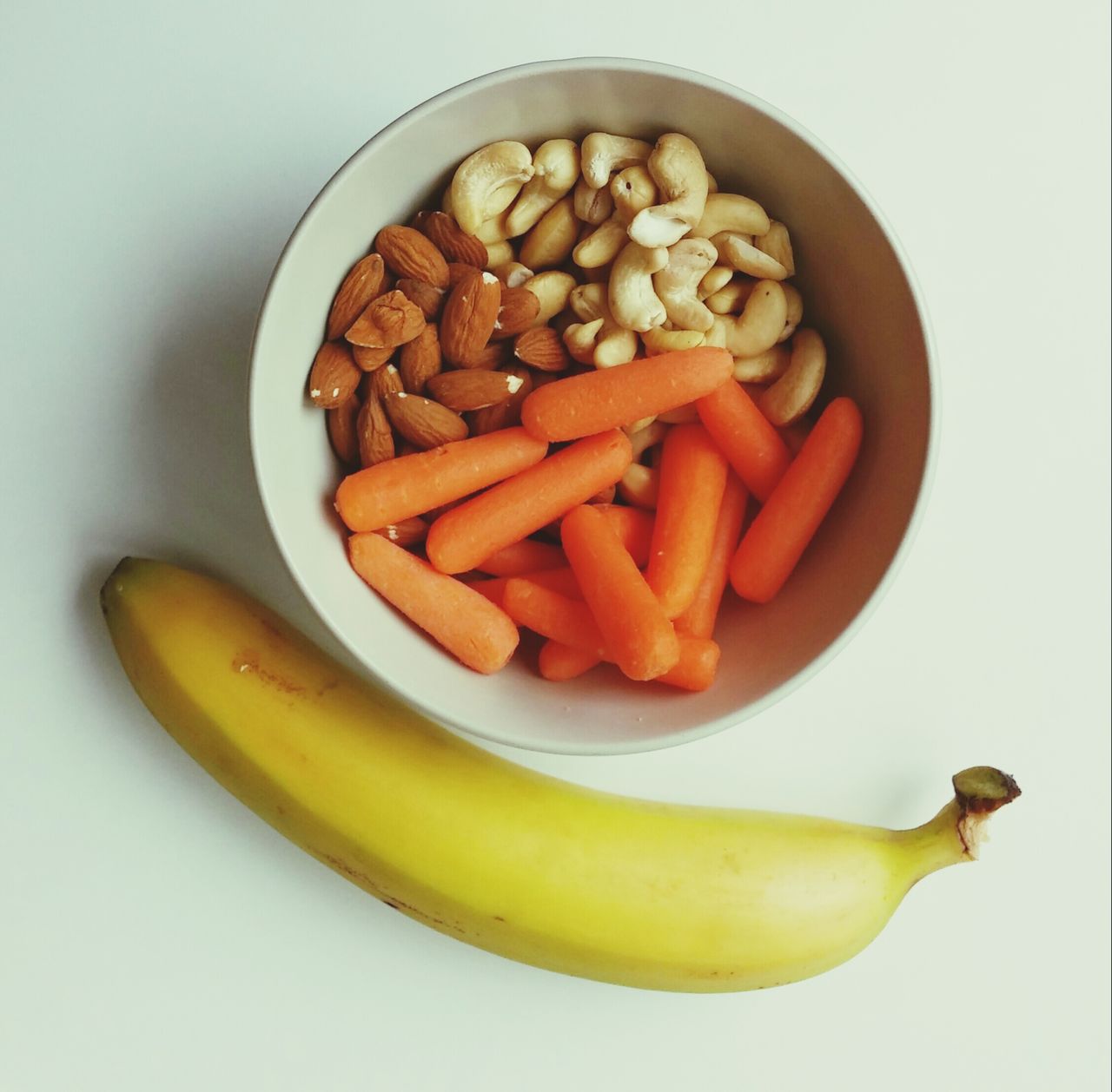 Studio shot of banana and carrots and nuts