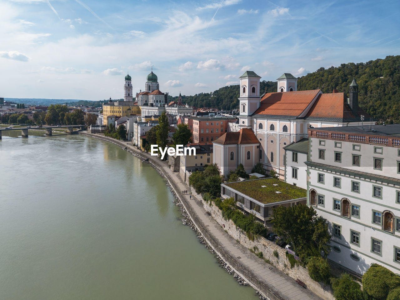 Germany, bavaria, passau, aerial view of innkai promenade in summer with st. stephens cathedral and st. michaels church in background