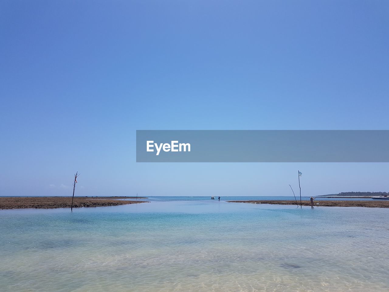 Scenic view of sea against clear blue sky