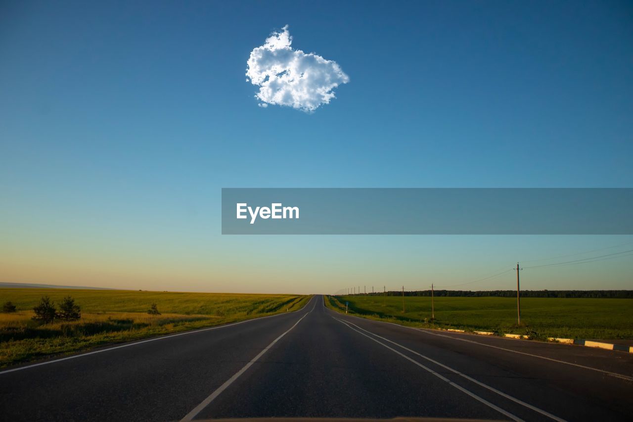 View of country road against clear blue sky