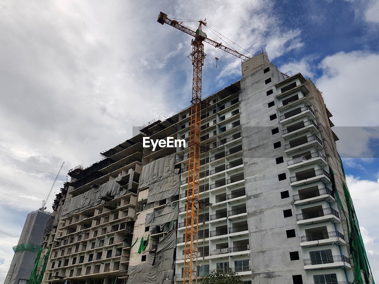 LOW ANGLE VIEW OF BUILDING AT CONSTRUCTION SITE