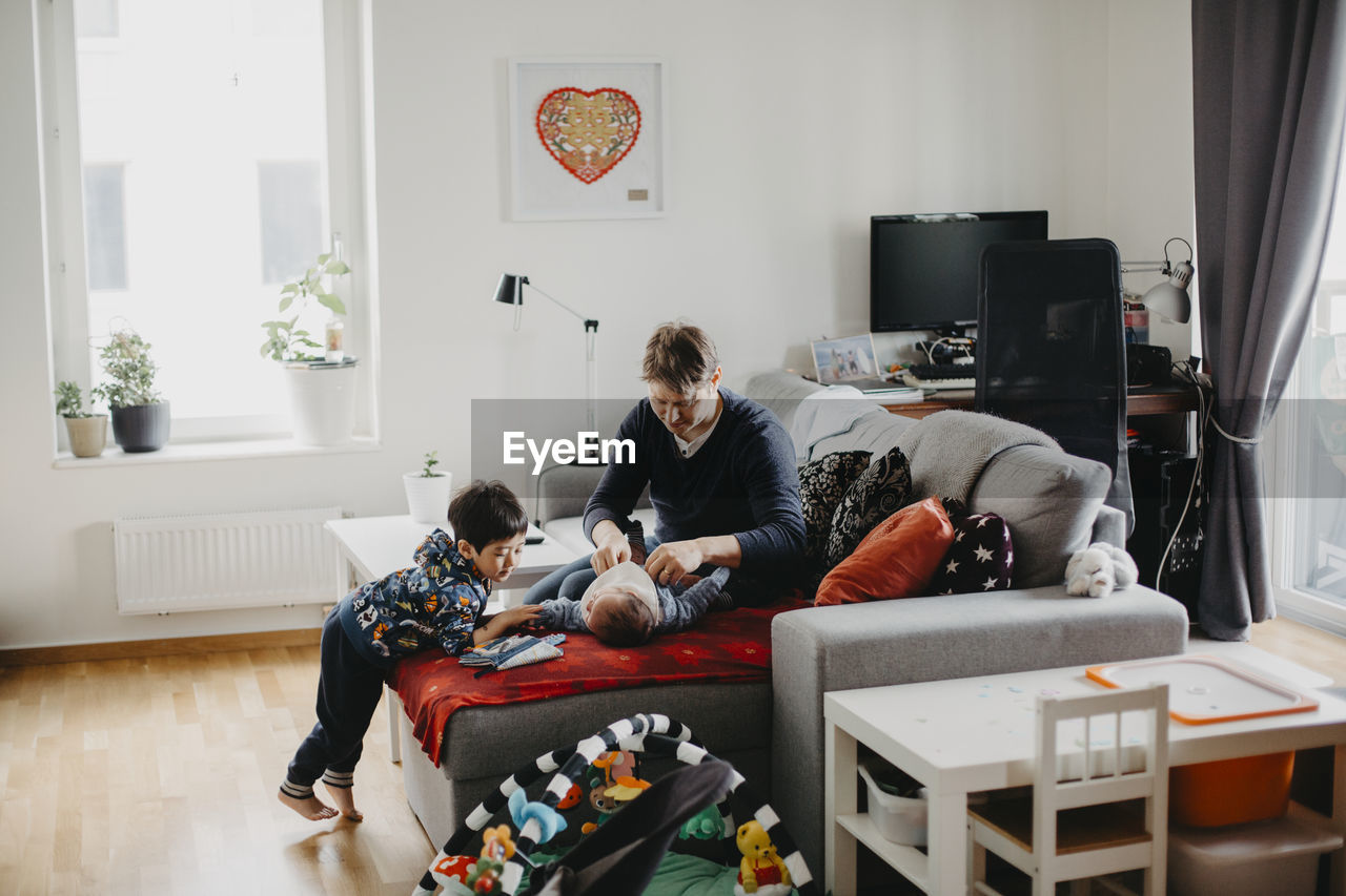 Father with children in living room