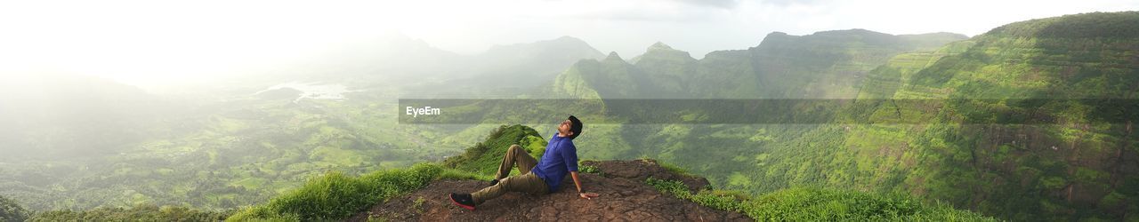 High angle view of man relaxing on mountain