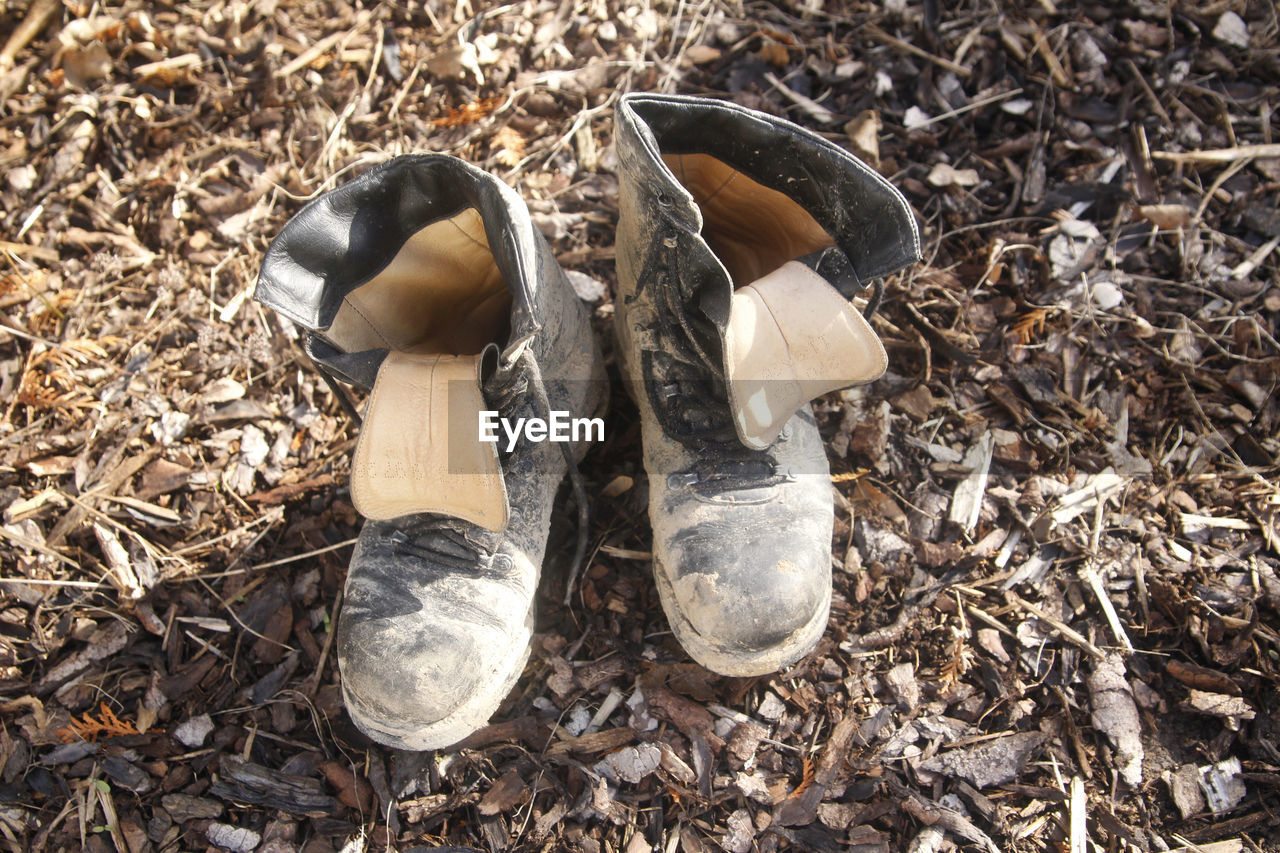 HIGH ANGLE VIEW OF SHOES IN MUD