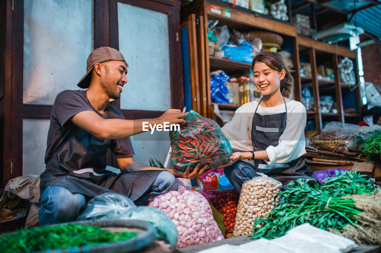 portrait of smiling young woman sitting in baskets