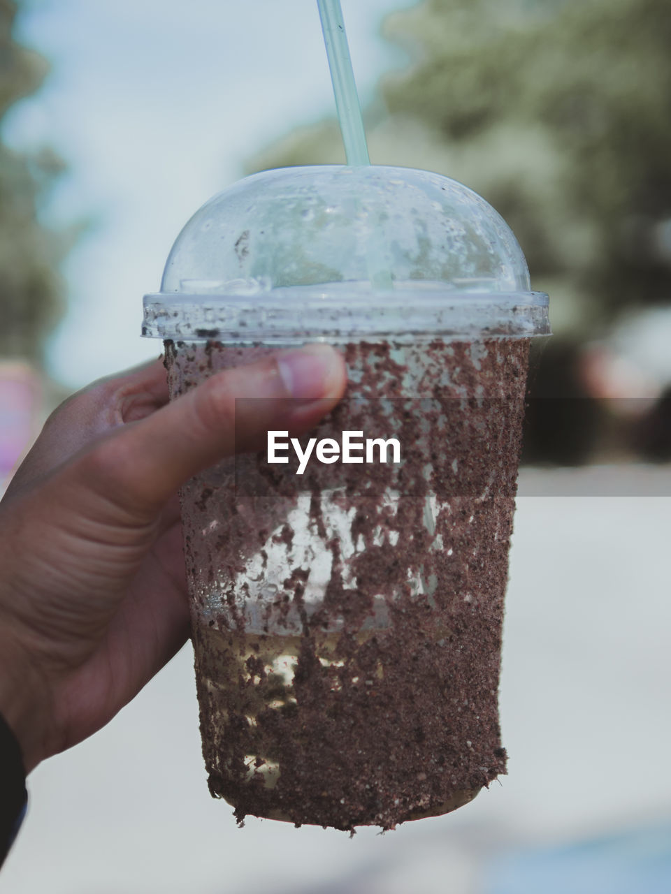 CLOSE-UP OF HAND HOLDING ICE CREAM CONE