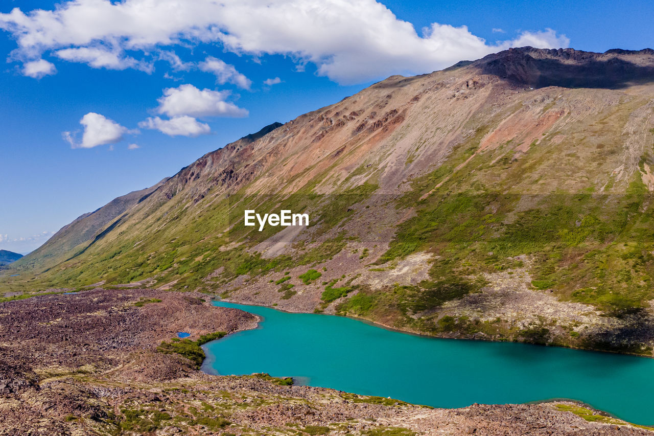 SCENIC VIEW OF LAKE BY MOUNTAIN AGAINST SKY