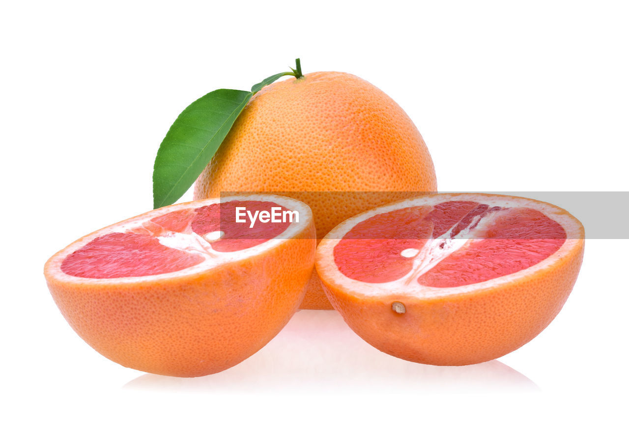 CLOSE-UP OF ORANGE SLICE AGAINST WHITE BACKGROUND