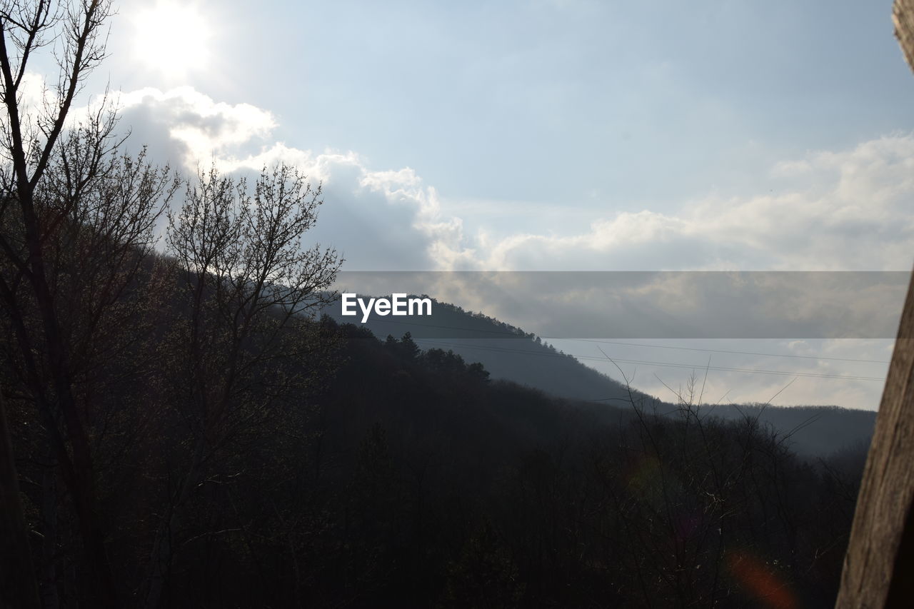 SCENIC VIEW OF MOUNTAINS AGAINST CLOUDY SKY