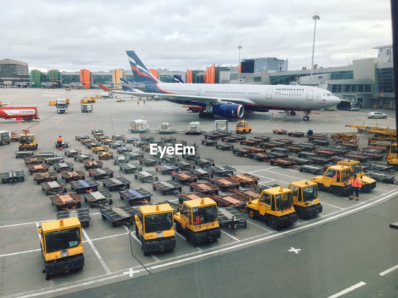 HIGH ANGLE VIEW OF AIRPLANE ON AIRPORT RUNWAY