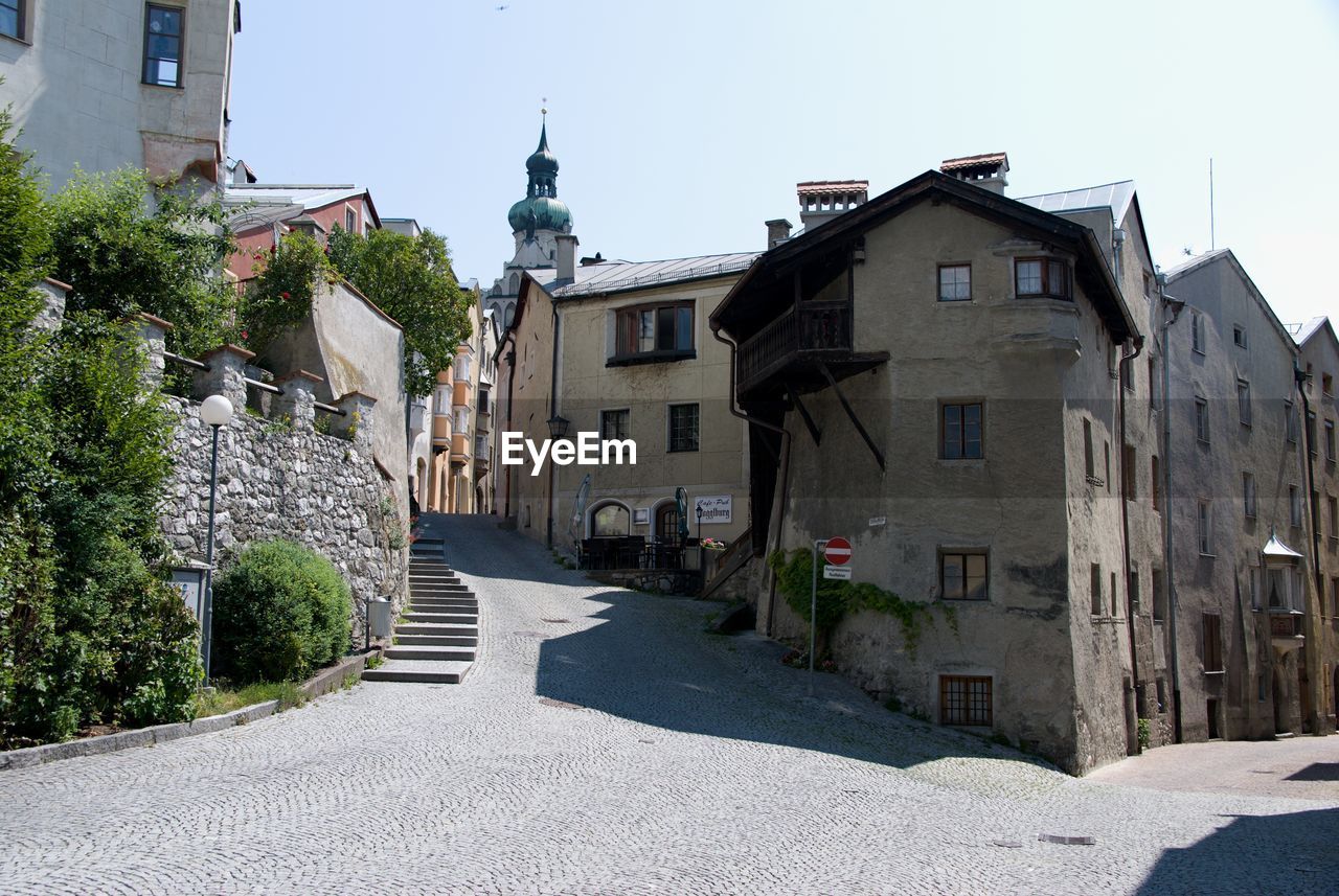 STREET AMIDST BUILDINGS AGAINST SKY