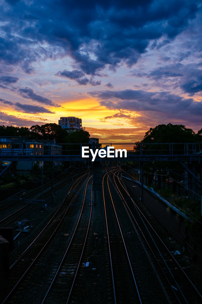 High angle view of railroad tracks against sky at sunset