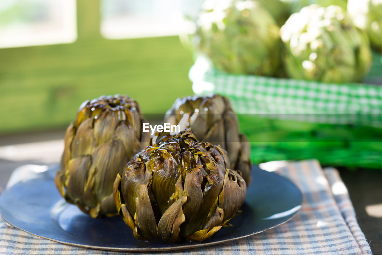 Close-up of artichokes in plate on table