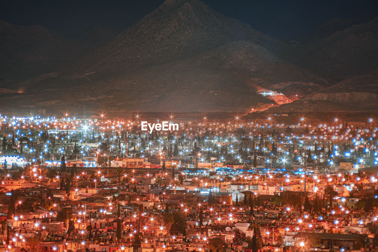 High angle view of illuminated buildings in city at night