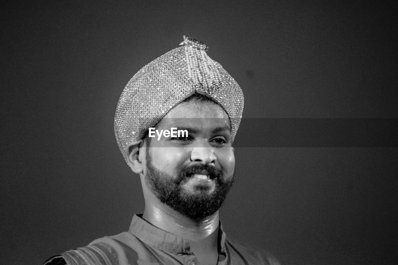 portrait, black, white, one person, headshot, facial hair, black and white, beard, adult, monochrome photography, monochrome, front view, indoors, studio shot, men, hat, looking at camera, clothing, moustache, young adult, person, close-up, darkness, copy space, looking, lifestyles, human face