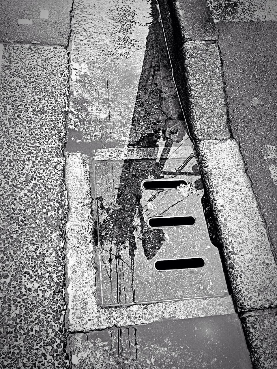 Reflection telephone pole on puddle