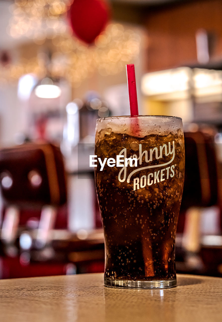 CLOSE-UP OF DRINK IN GLASS ON TABLE AT RESTAURANT