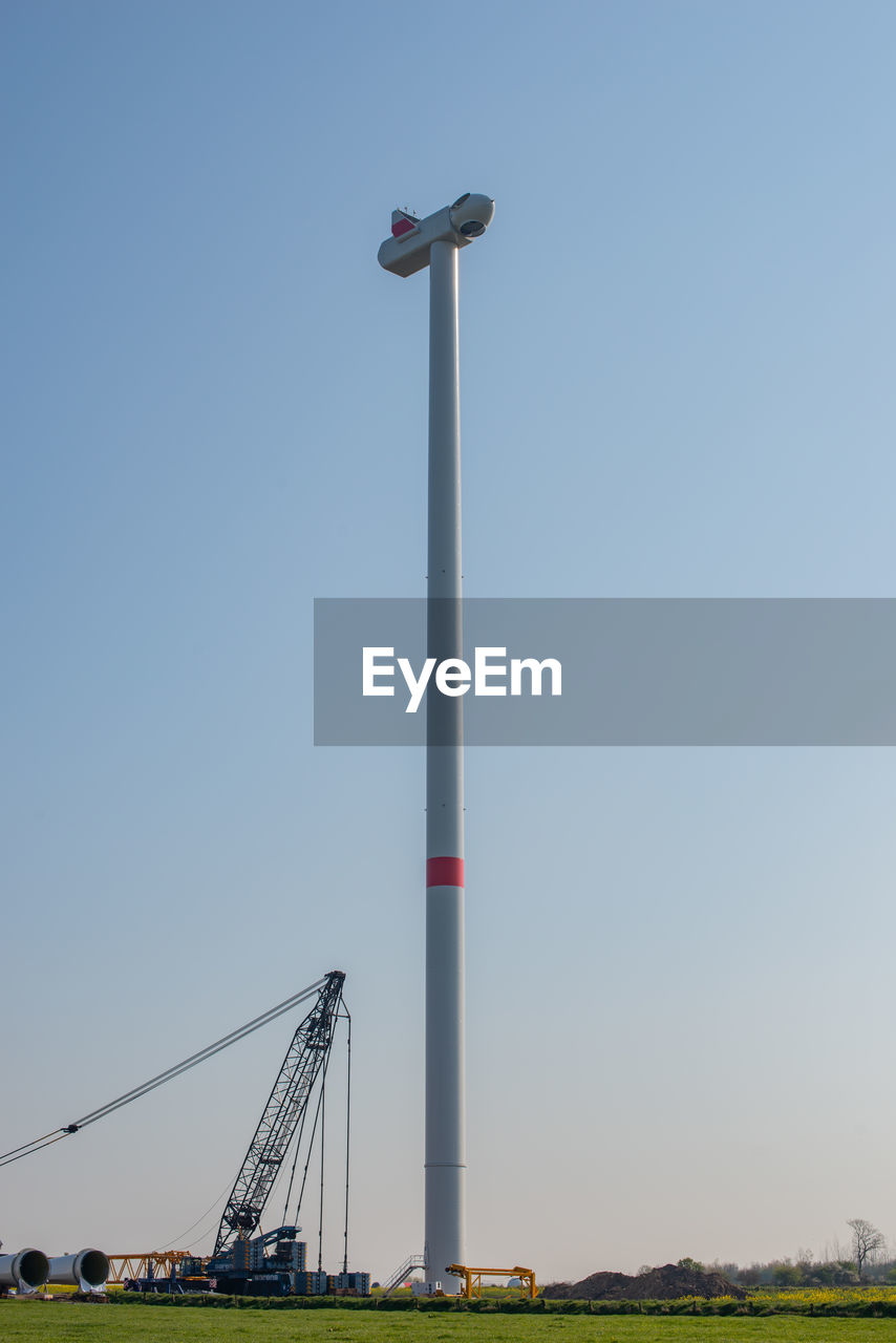 LOW ANGLE VIEW OF WINDMILL AGAINST CLEAR SKY