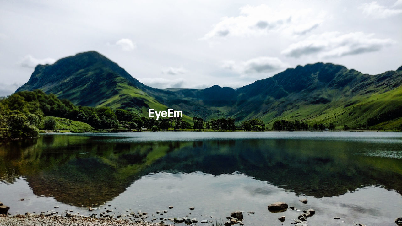 Scenic view of lake and mountains against sky