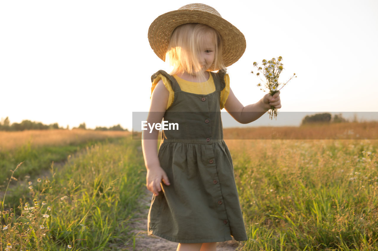 Full length of cute girl standing on field