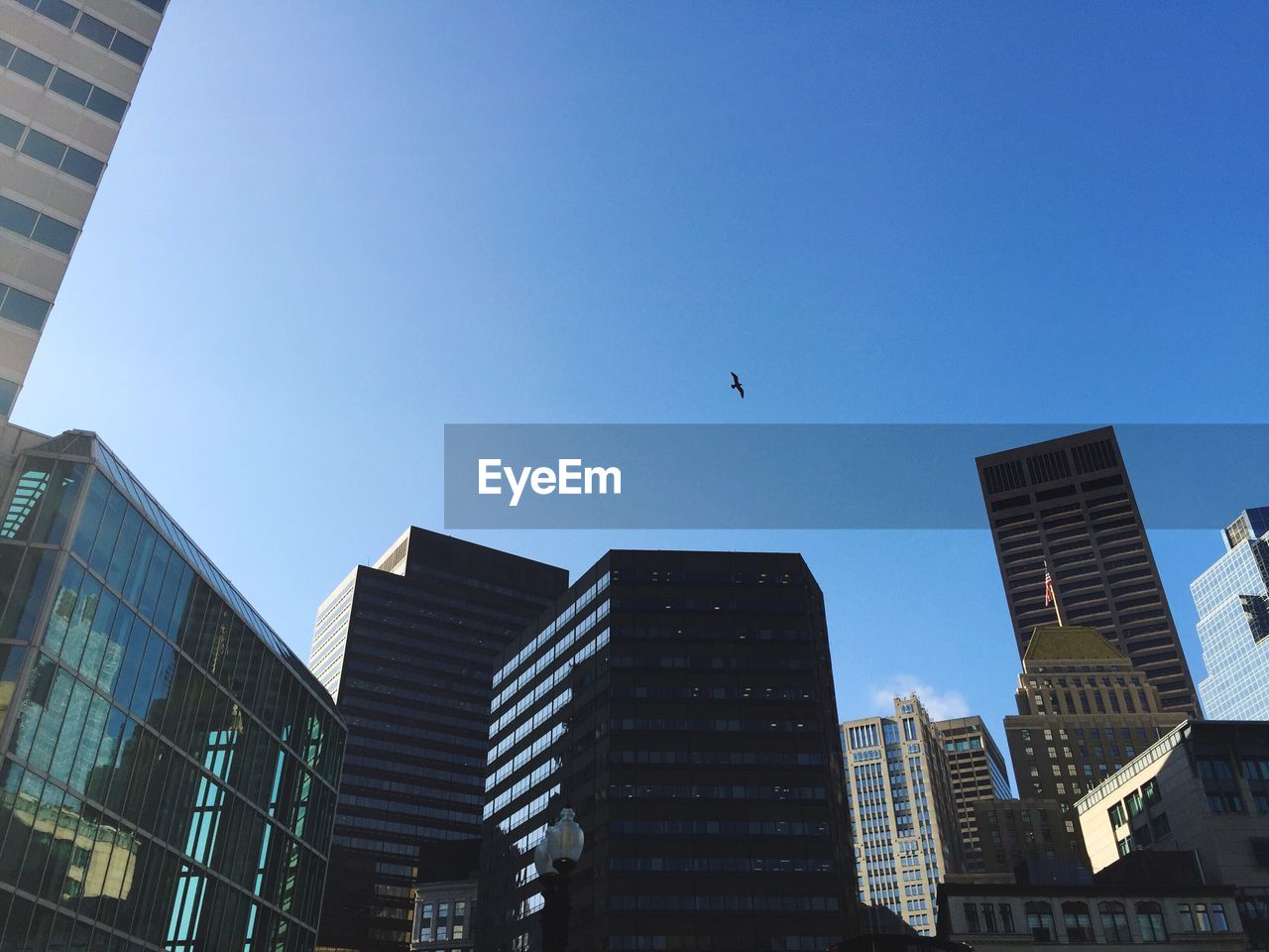 Low angle view of modern buildings against blue sky