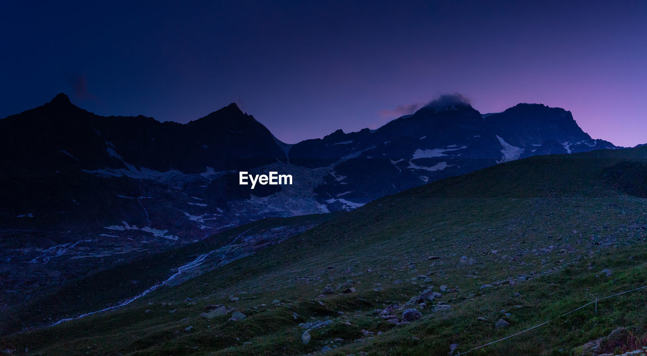 Scenic view of snowcapped mountains against clear sky