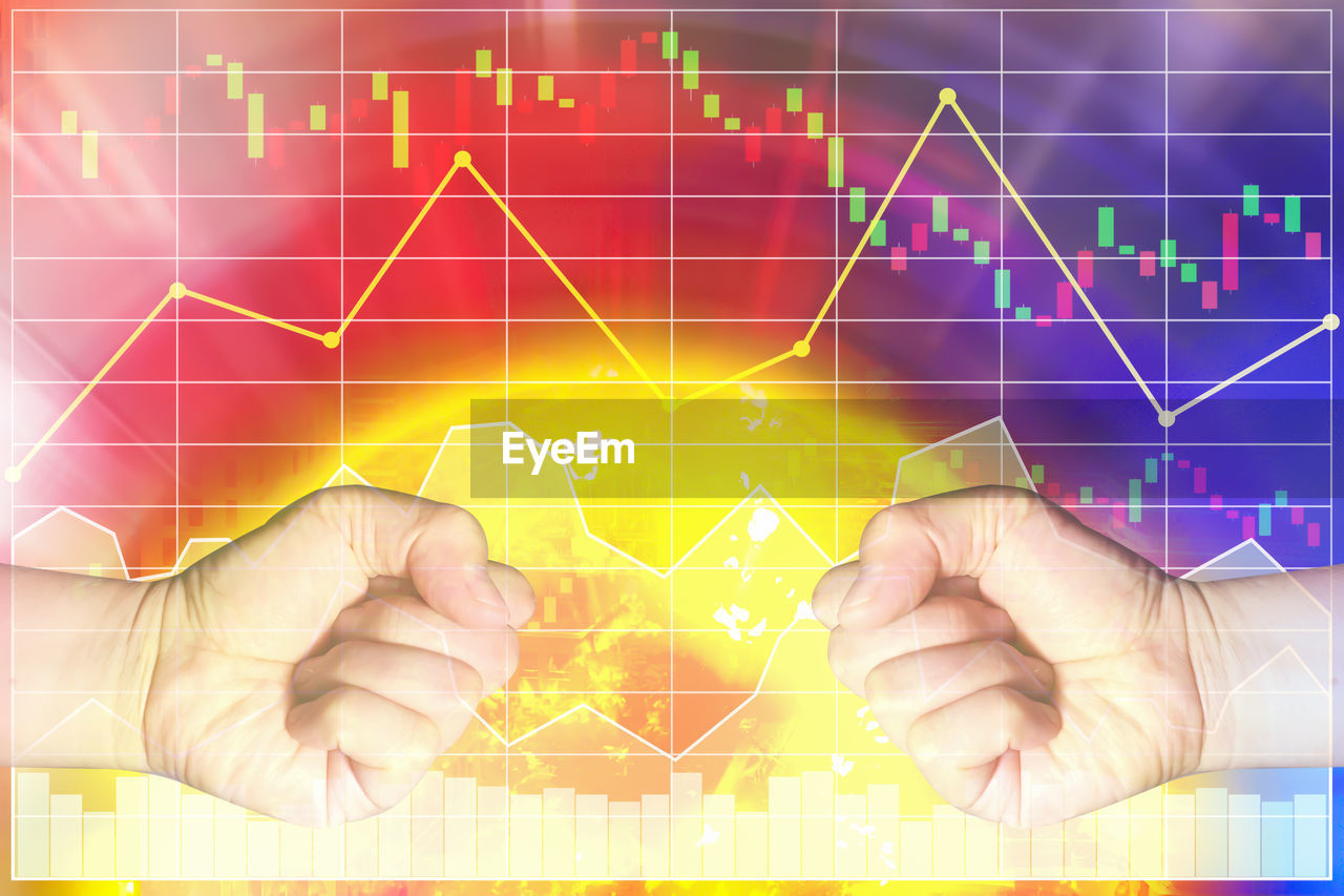 Digital composite image of fist and stock market chart
