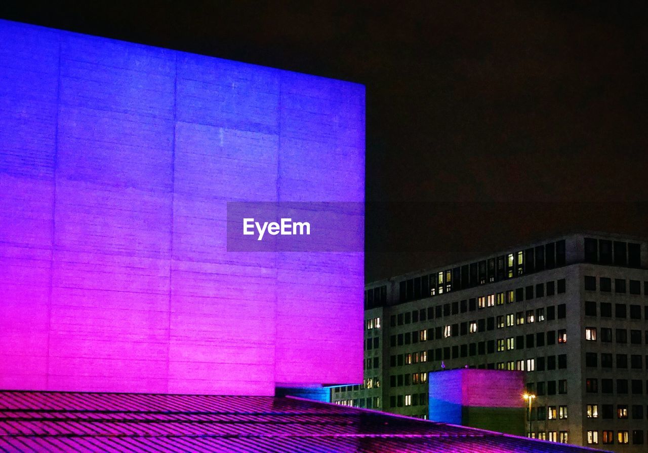 VIEW OF ILLUMINATED CITY AT NIGHT