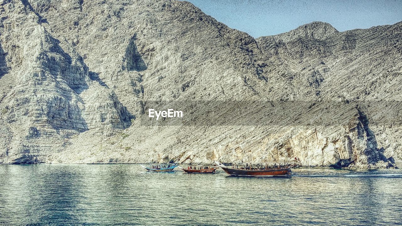 BOATS SAILING IN SEA