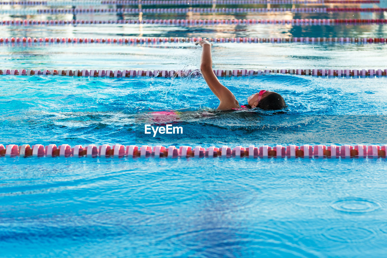 High angle view of girl swimming in pool