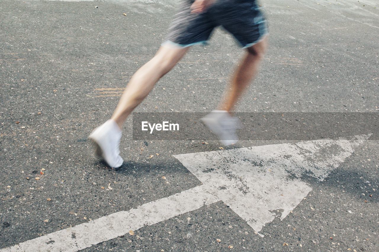 LOW SECTION OF MAN WALKING ON STREET