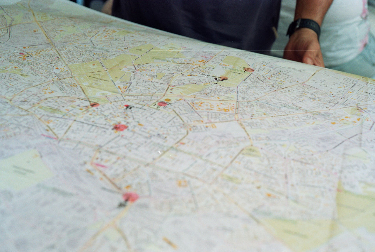 Midsection of man standing in front of map