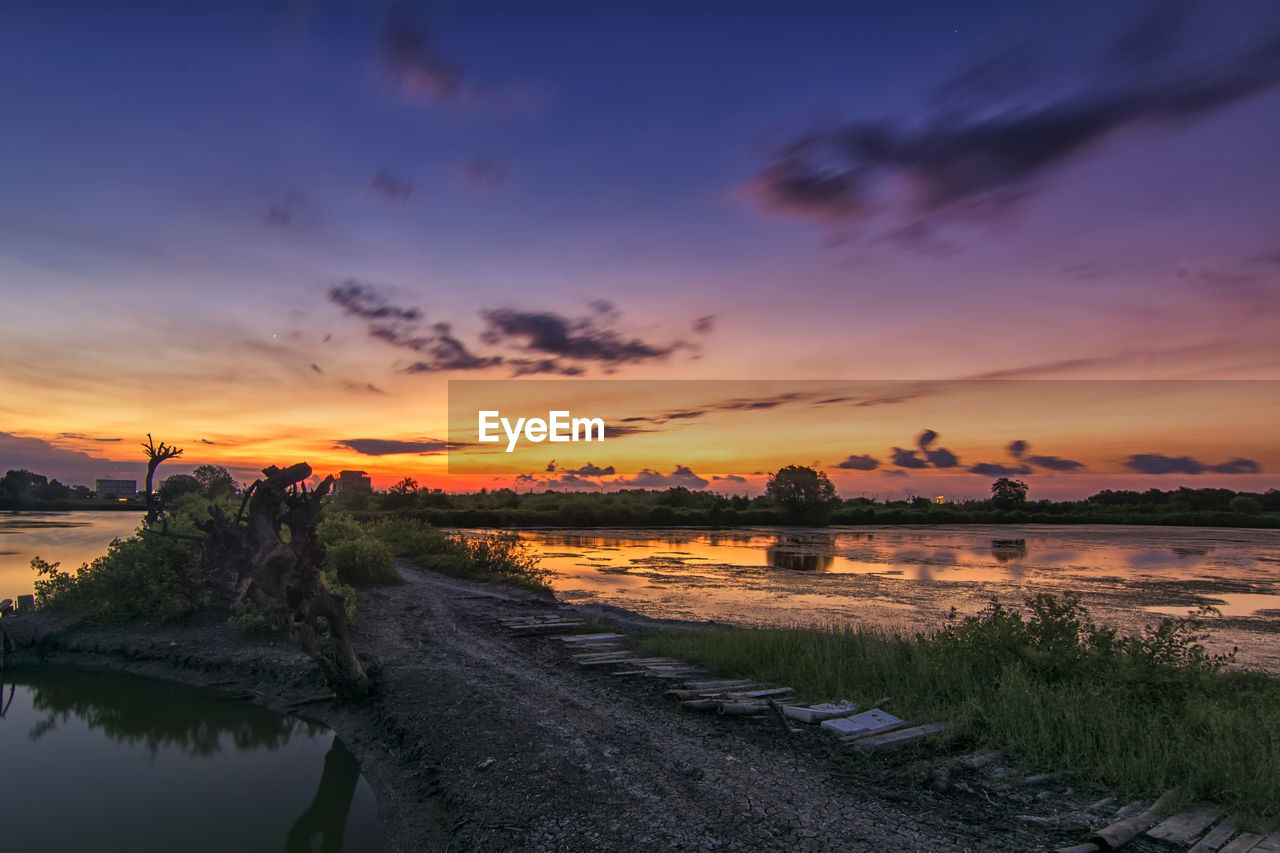 Scenic view of lake against sky during sunset