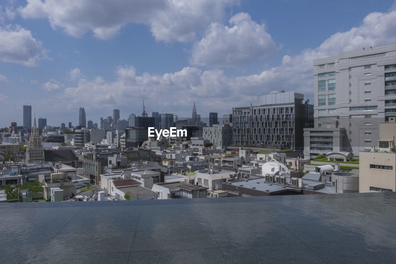 Buildings against cloudy sky