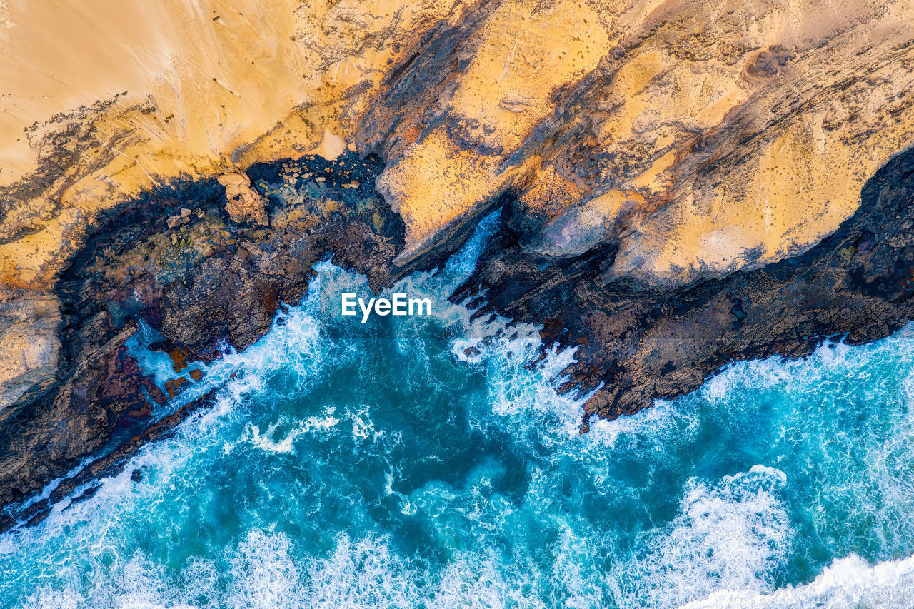 High angle view of rock formation in sea