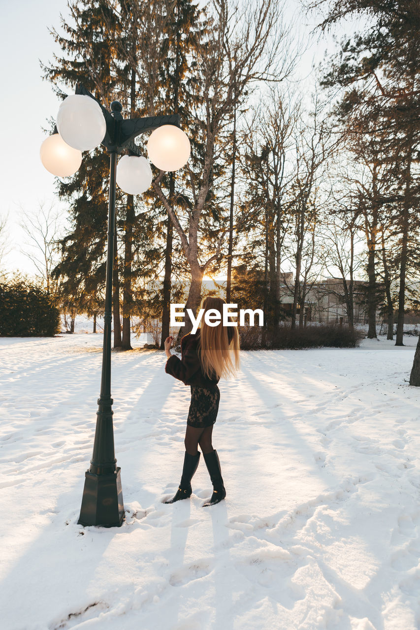 Full length of woman standing on snow field