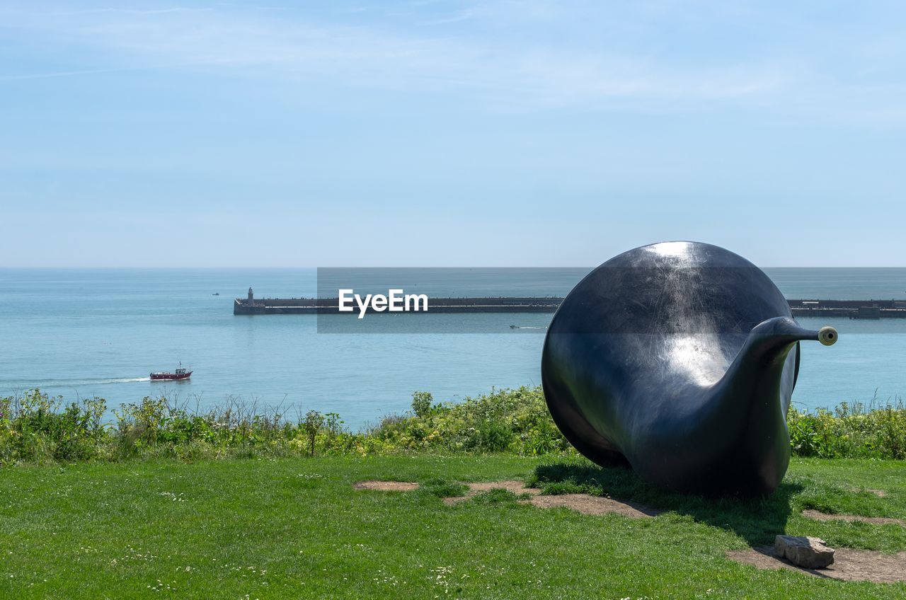 Siren sculpture overlooking the folkestone harbour arm and the english channel in kent, england