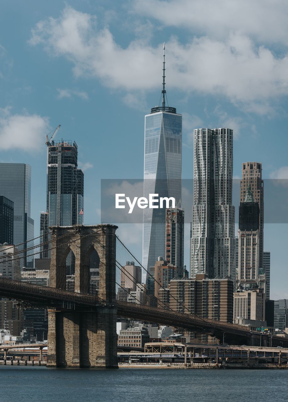 View of skyscrapers against cloudy sky